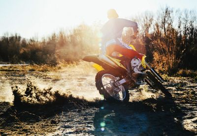 Rear view of person riding motorbike