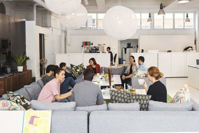 Multi-ethnic business people discussing project in modern office lobby