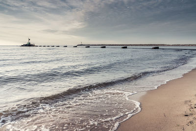 View of beach against cloudy sky