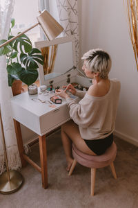 Boy sitting on table at home