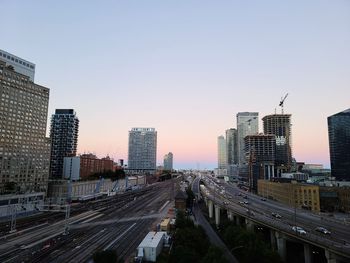 High angle view of street amidst buildings against clear sky