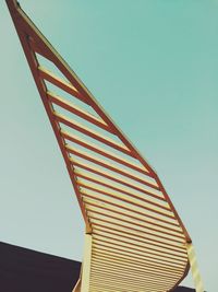 Low angle view of red umbrella against clear blue sky