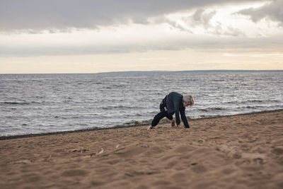 Full length of man on beach against sky