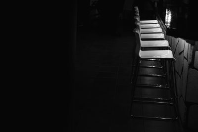 High angle view of empty chairs arranged in darkroom