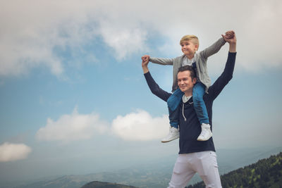 Father and son spending leisure time on mountain