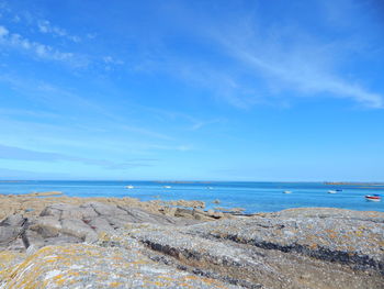 Boats in sea against blue sky