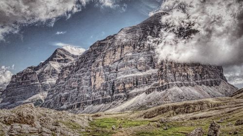 Low angle view of rocky mountains against sky