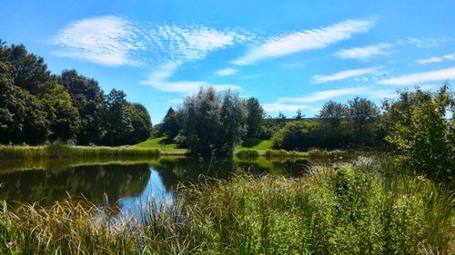 Scenic view of lake against cloudy sky