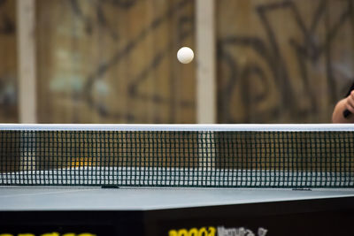 Ball in mid-air above table tennis table