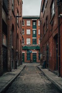 Empty alley amidst residential buildings