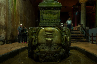 Statue of buddha against building