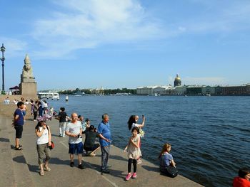 People in front of river