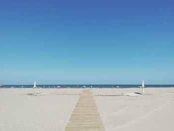 Wooden jetty leading to calm sea