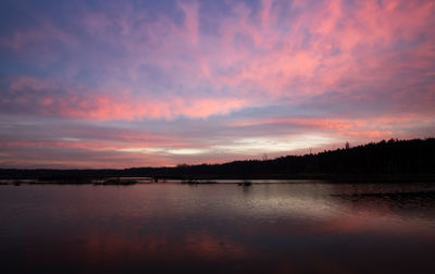 Scenic view of lake against romantic sky at sunset