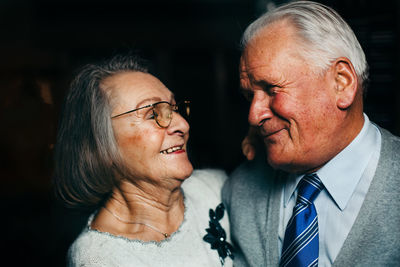 Close-up of senior couple smiling in darkroom