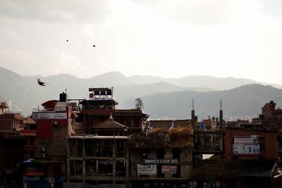 Buildings in city against sky