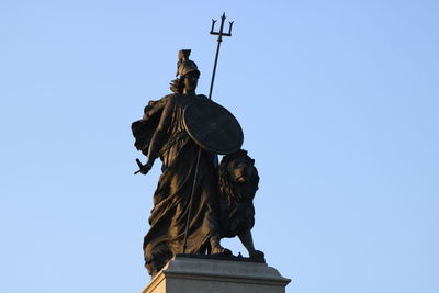 Low angle view of angel statue against clear sky