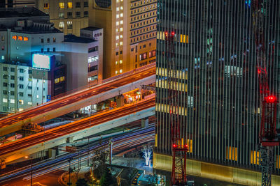 Illuminated city street and buildings at night