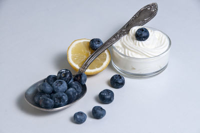 High angle view of fruits in bowl against white background