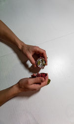 High angle view of hand holding bread on table