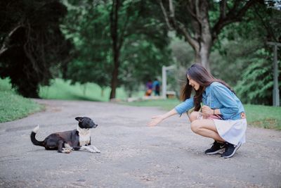 Young woman playing with dog