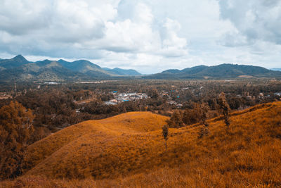 Scenic view of landscape and mountains against sky