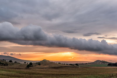 Scenic view of field against sky during sunset