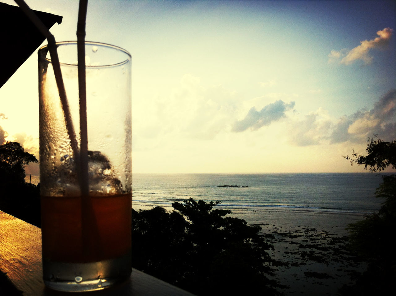 sea, drink, horizon over water, water, food and drink, sky, refreshment, glass - material, drinking glass, freshness, sunset, transparent, table, close-up, beach, window, scenics, nature, glass, cloud
