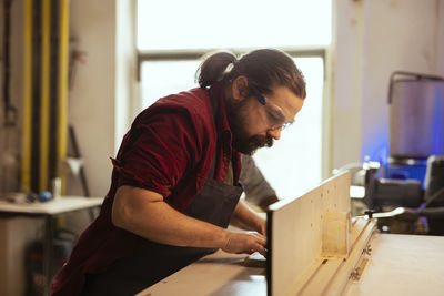 Side view of man working at home