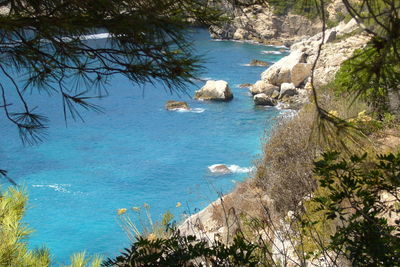 High angle view of rocks by sea