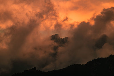 Low angle view of silhouette mountain against sky during sunset