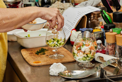 Cropped hand of person preparing food