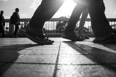 Low section of people walking on footpath