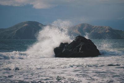 Waves breaking against sea