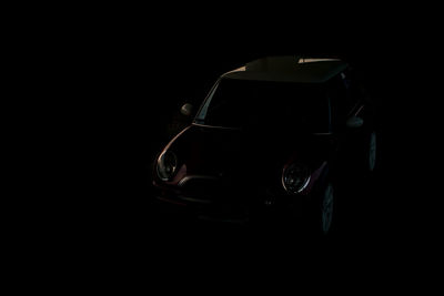 Close-up of car over black background