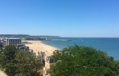 Scenic view of sea and coastline against clear and blue sky 