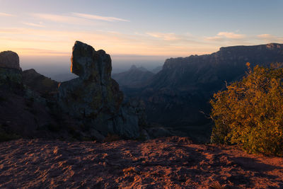 Rock formations on mountain against sky during sunset