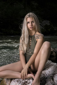 Portrait of beautiful woman sitting in water