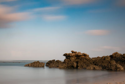 Scenic view of sea and rocks against sky