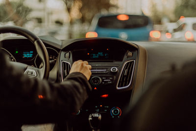 Cropped hand driving car