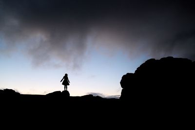 Low angle view of silhouette mountains against sky at sunset