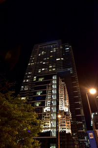 Low angle view of modern building at night