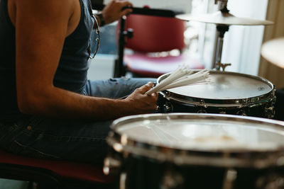 Midsection of man playing guitar