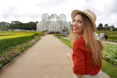 Woman with hat walking in the botanical garden of curitiba,  parana, brazil