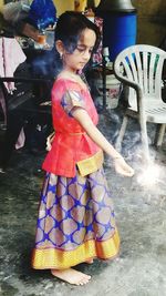 Girl standing in traditional clothing