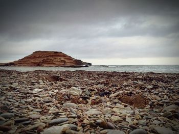 Rocks on beach against sky