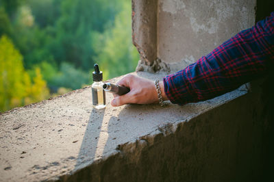 Close-up of man holding electronic cigarette