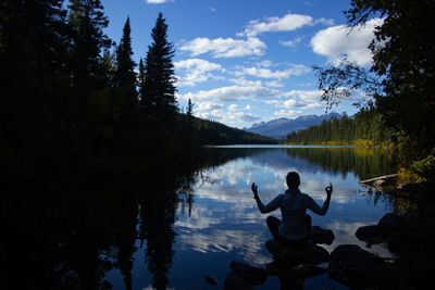 Rear view of man standing in lake