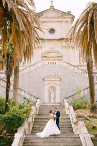 Couple walking in front of building