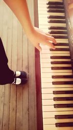 Low section of child playing piano